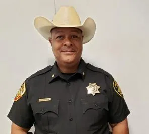 A man in a cowboy hat and uniform.